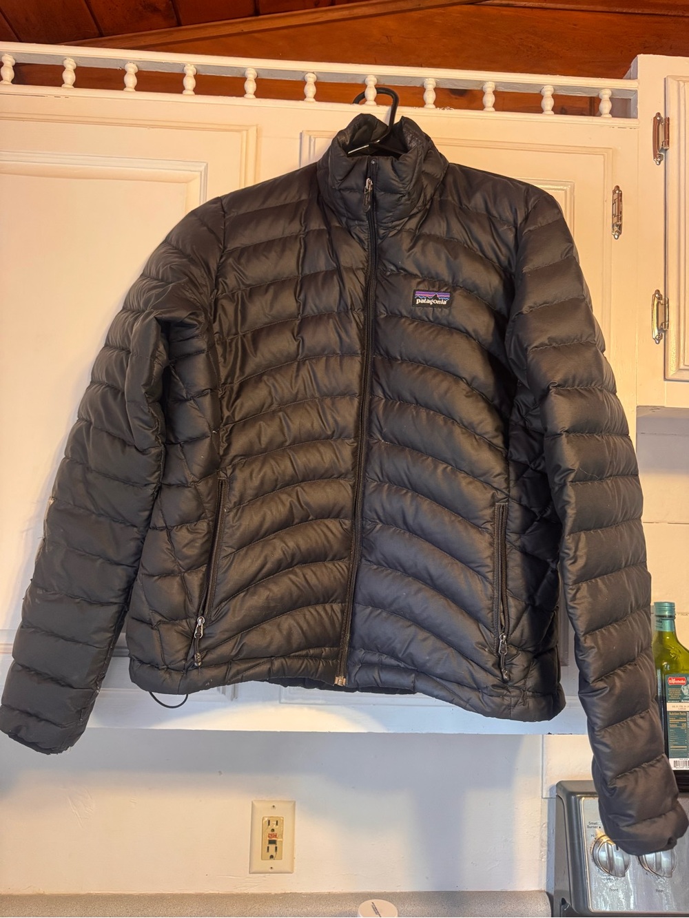 Patagonia nano puff black Women's Puffer Jacket  has repair tape on arm
